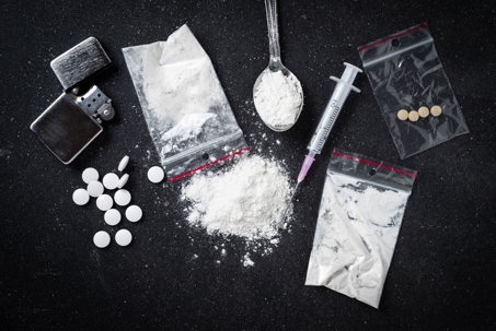 illegal drugs, hard drugs on dark table, controlled substances